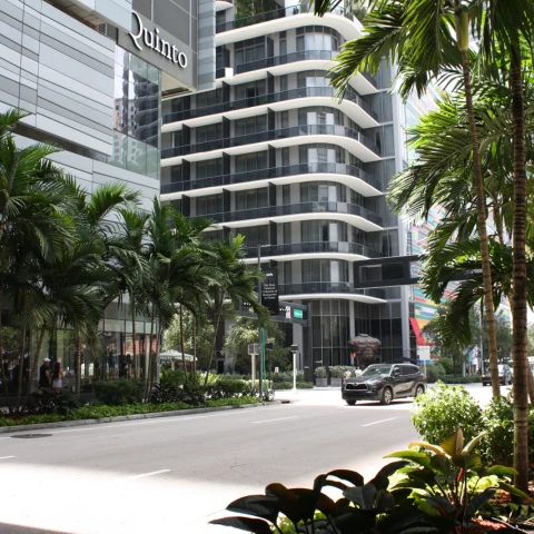 A tall building with many windows in a Miami skyline